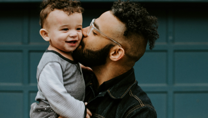 Father kissing child